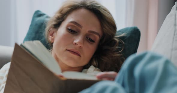 Peaceful Young Girl Enjoying Interesting Book