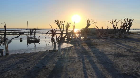 Low level slow pan shot capturing beautiful sunset at Epecuen village that was once a thriving touri