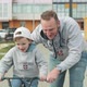A Father Cheering Up Son on His First Bicycle Ride - VideoHive Item for Sale