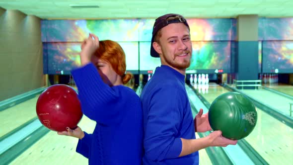 Boy and Girl Dance with Bowling Balls