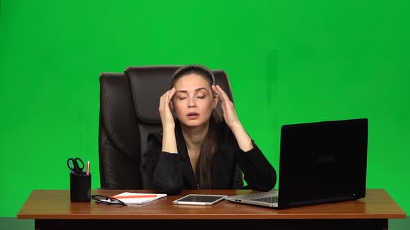 Business Woman in the Workplace Feels Tired After a Hard Working Day. Green Screen