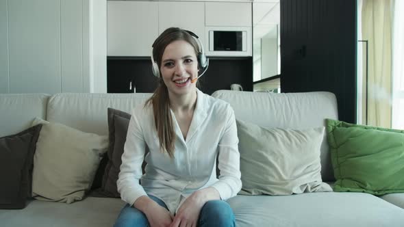 Young Business Woman Talks To Web Camera Making Distance Online Video Conference Call.