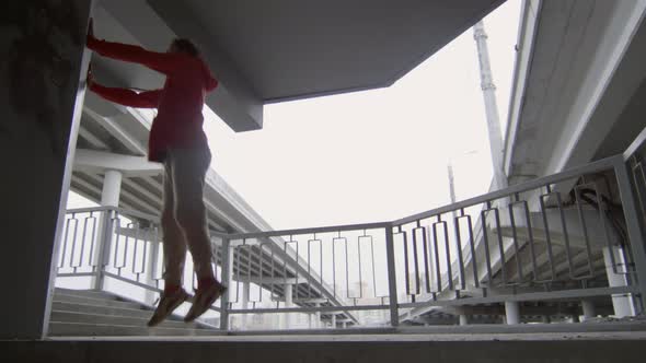 Parkourist Doing Wall Backflip on Urban Staircase