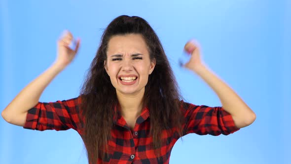 Young Female Is Closing Her Ears and Shouting