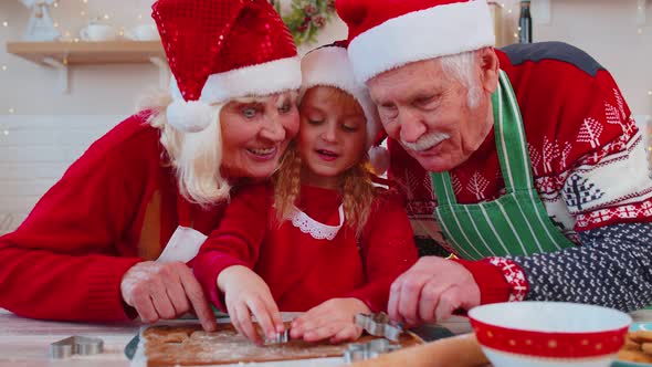 Senior Old Grandparents with Grandchild Girl Kid Preparing Cooking Cookie at Home Christmas Kitchen