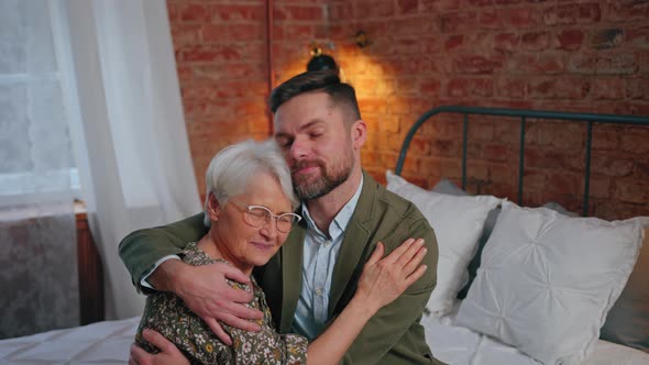 Happy Caucasian Mother and Son Hugging and Celebrating Mother's Day