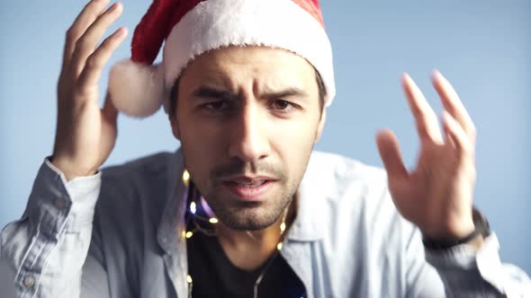 Closeup Footage of Young Attractive Man in Santa Claus Red Hat After Celebration or Long Night