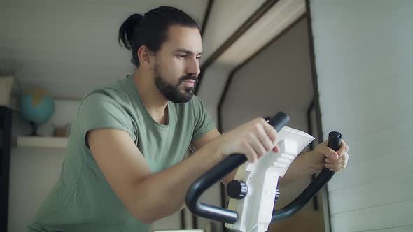 Fitness man on a bicycle doing spinning at the gym. 