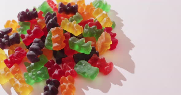 Video of colourful jelly candy on white background