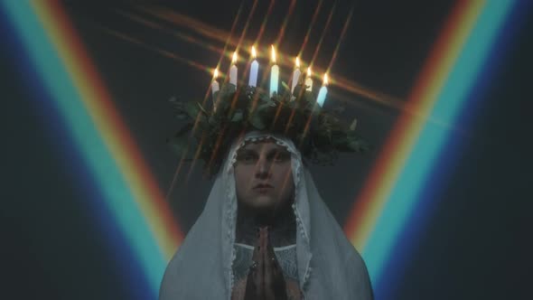 Praying Man with Candle Lit Wreath on Head