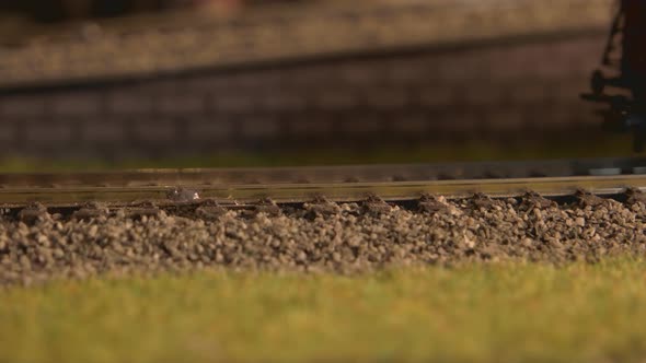 Toy Steam Train with Wagons Moving on Railroad.