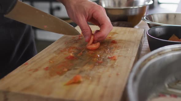 Caucasian male chef cutting vegetables