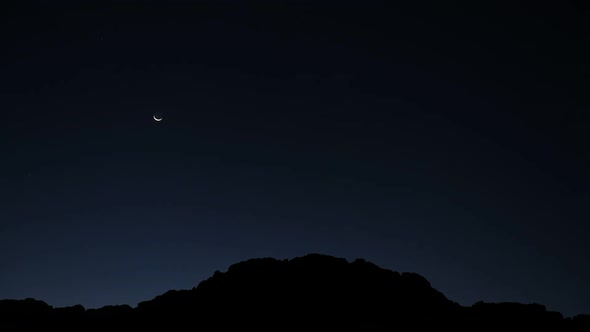 Time lapse of night falling over traquil landscape