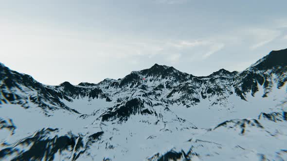 Canada flag above the snowy mountains. 4K Aerial View