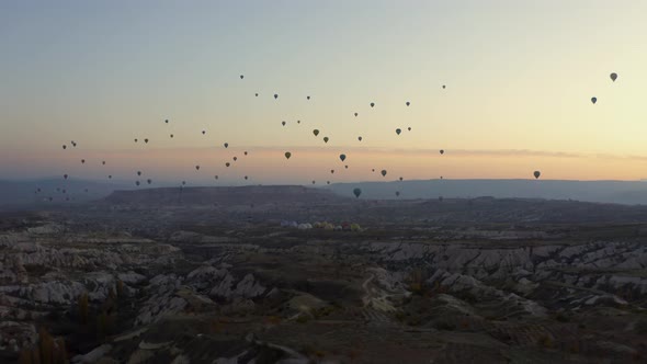 Hot Air Balloons Over Rocky Mountains During Sunset