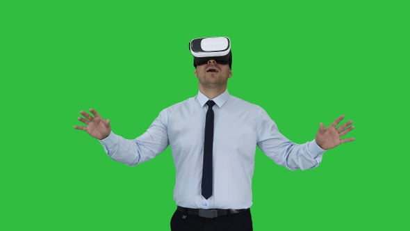 Astonished young businessman wearing VR glasses Concept
