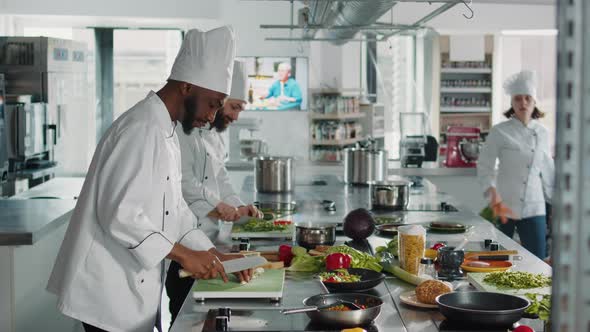 African American Cook Using Aromatic Garlic Clove to Do Culinary Recipe