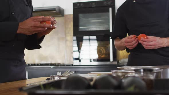 Caucasian female chef teaching diverse group