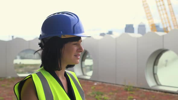 Woman at construction site using walkietalkie