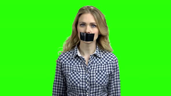 Young Angry Woman with Black Tape on Her Mouth