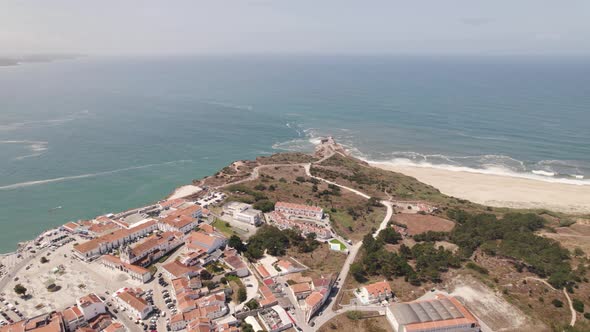Nazare village and famous beach with sea in background, Portugal. Aerial panoramic view
