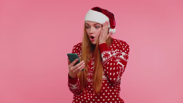 Woman in Stylish Christmas Sweater Looking Smartphone Display Sincerely Rejoicing Win Success Luck