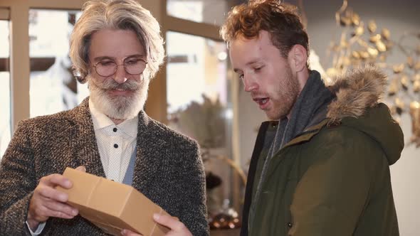 Man and Senior Florist Consultant Choosing Bouquet at Flowers Shop