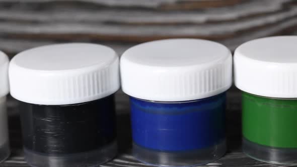 A Set Of Gouache And Brushes.  On Pine Boards.  Slider Camera. Close Up. alt