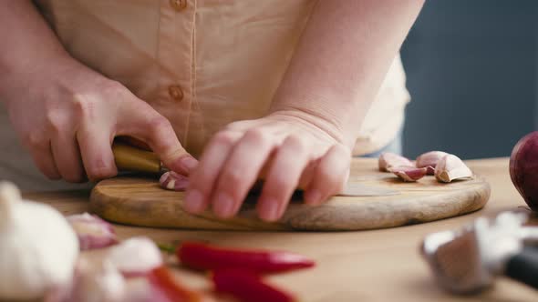 Woman using fresh garlic in the kitchen. Shot with RED helium camera in 4K.