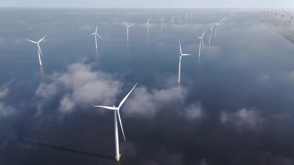 Offshore Windmill Park with Clouds and a Blue Sky Windmill Park in the Ocean Drone Aerial View with