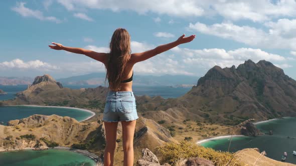 Girl Raises Hands and Enjoys Nature of Indonesia