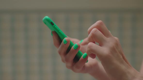 Close Up of Female Hands Using Mobile Phone and Surfing Online