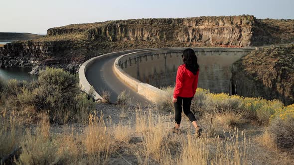 Asian woman hiking near the Salmon Falls Dam in Southern Idaho