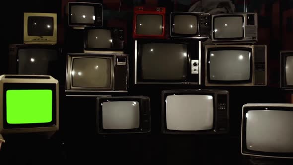 80s TV Turns On Green Screen, a Pile of Broken 1980s TVs in the Back.