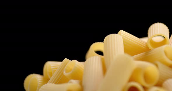 A Handful of Dry Pasta Cannelloni Rotates Slowly. 