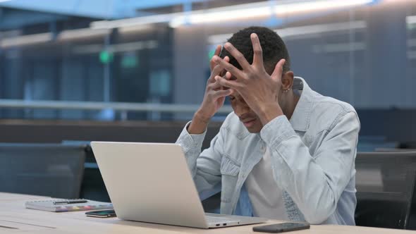 African Man with Laptop having Loss, Failure