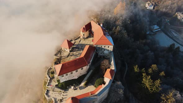 Dolly out reveal of panoramic landscape views surrounding Bled castle, Slovenia