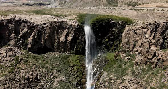 Aerial view of a crane shot of the inverted waterfall with a rainbow appearing all along its path on