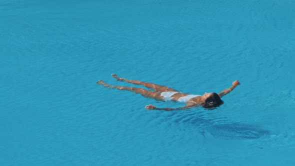 Woman Swimming on a Blue Water Pool