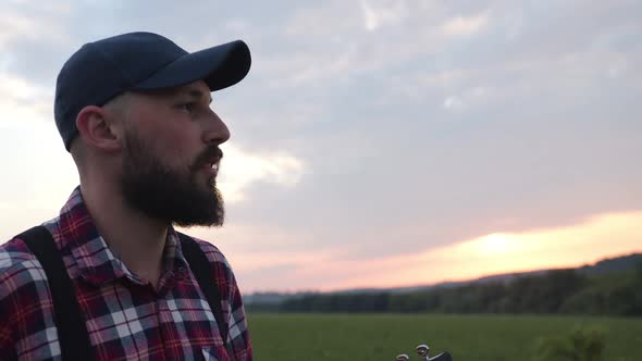 Caucasian Man Sings Song in the Countryside