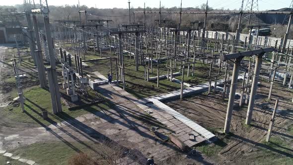Drone View of a Massive Power Station with Metal Structures and Power Lines