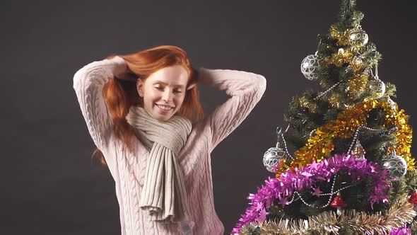 Studio Portrait of Redhead Girl Dancing in Christmas Party.