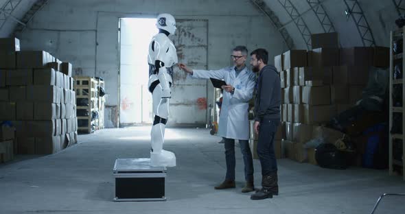 Engineers Testing Robot in a Warehouse