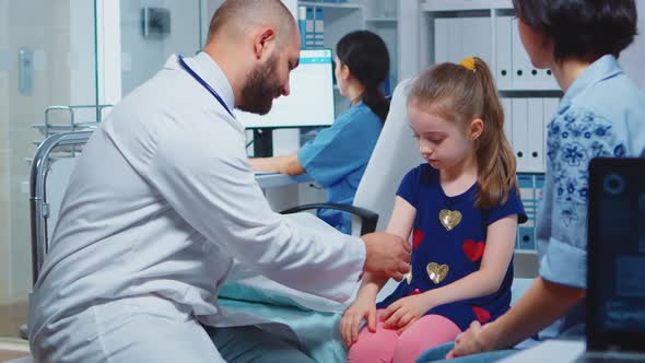 Medical Practitioner Bandaging Child Arm