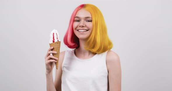 Smiling Model Teenager with Ice Cream in Waffle Cone Over Light Gray Studio Background