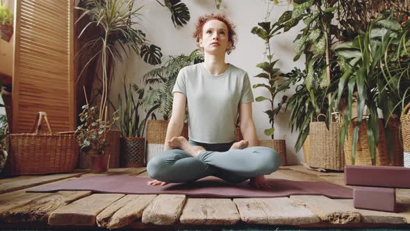 Woman Performing Scale Pose during Home Yoga Training