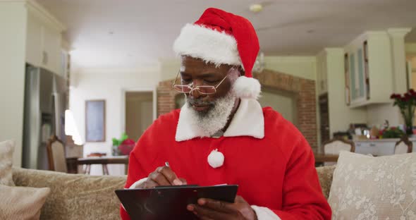 Senior african american man wearing santa costume at christmas time