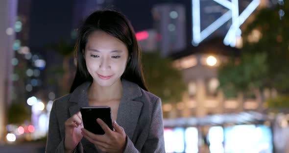 Businesswoman Use of Mobile Phone in City in The Evening