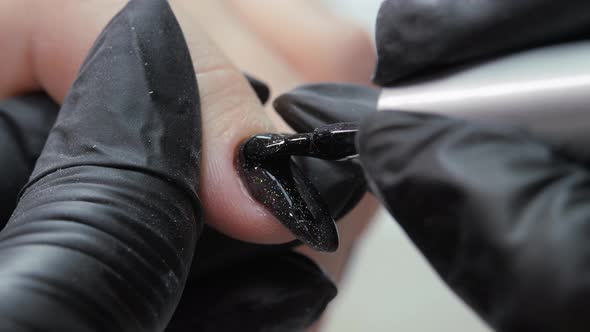 Applying a Second Layer of Black Lacquer to the Varnished Surface of the Nail