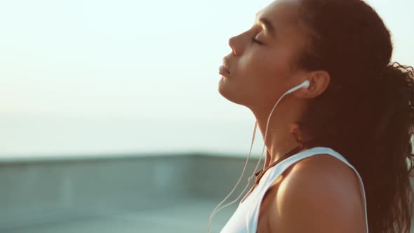 A side view of an attractive african american woman doing sport